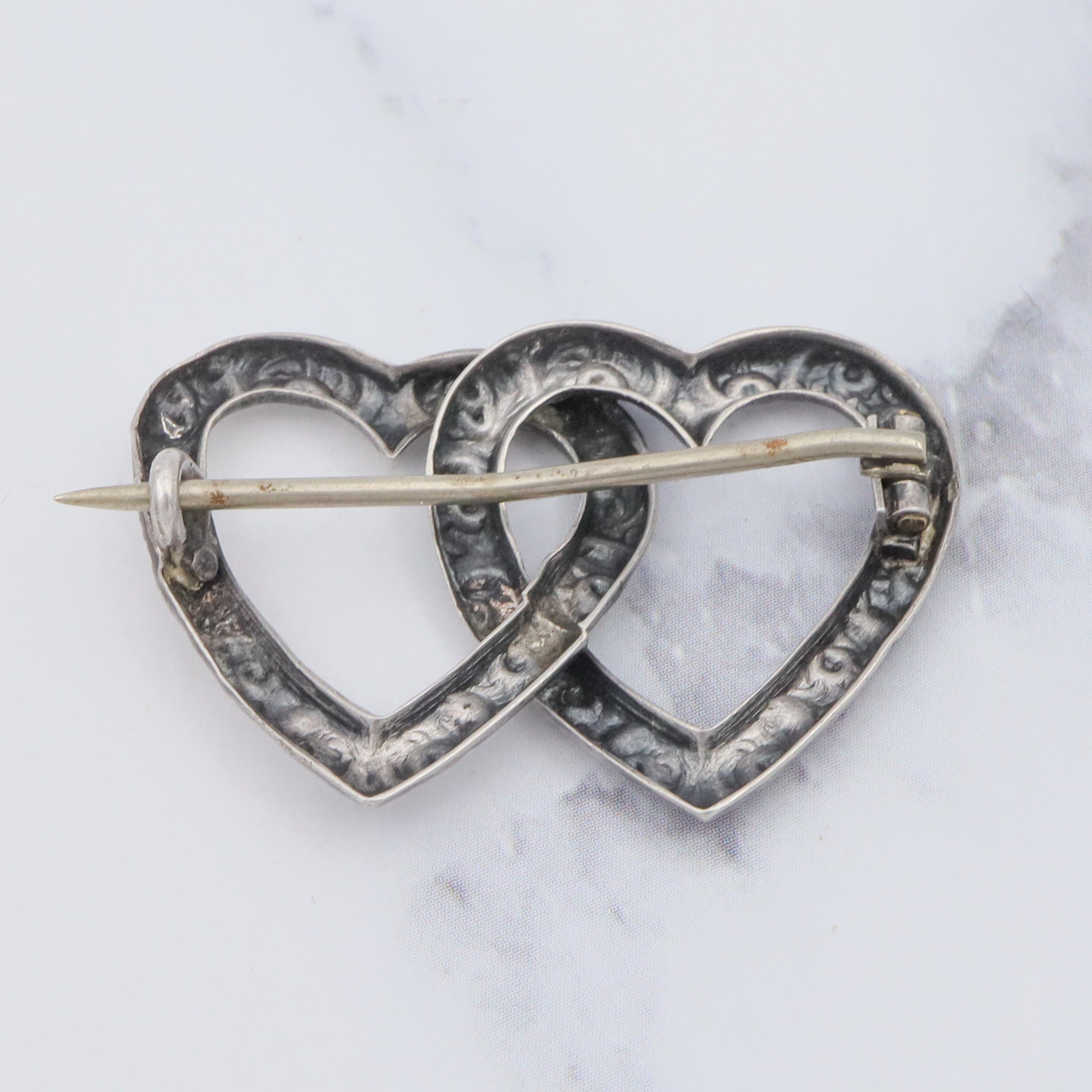 Antique Victorian sterling repousse double heart brooch